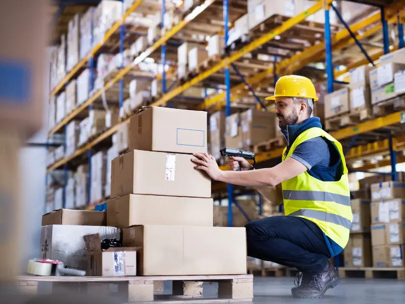Man in hard hat in a warehouse.