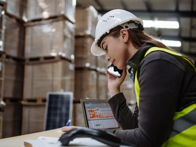 Woman in hard hat inside a warehouse