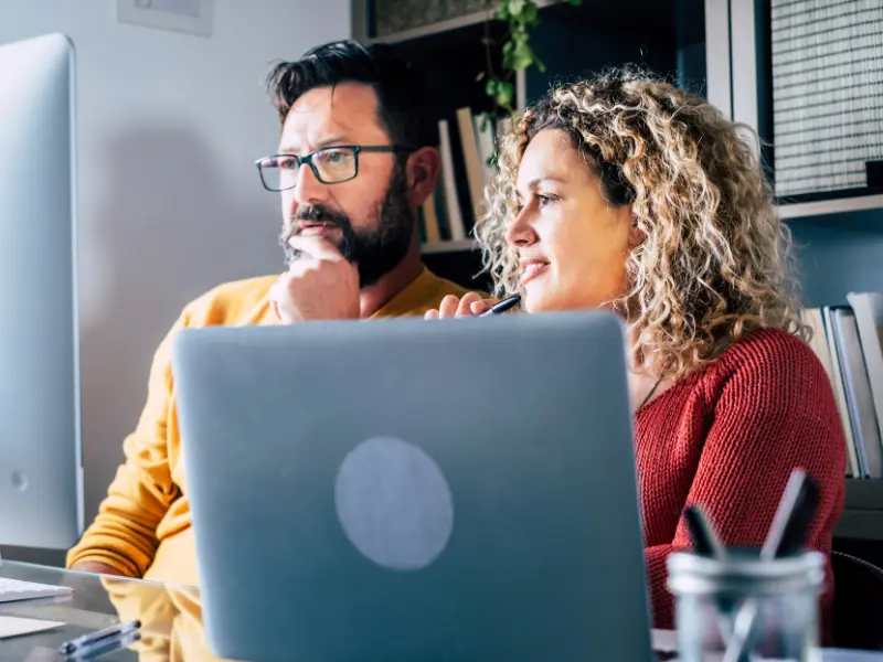 Man and woman working in front of a laptop.